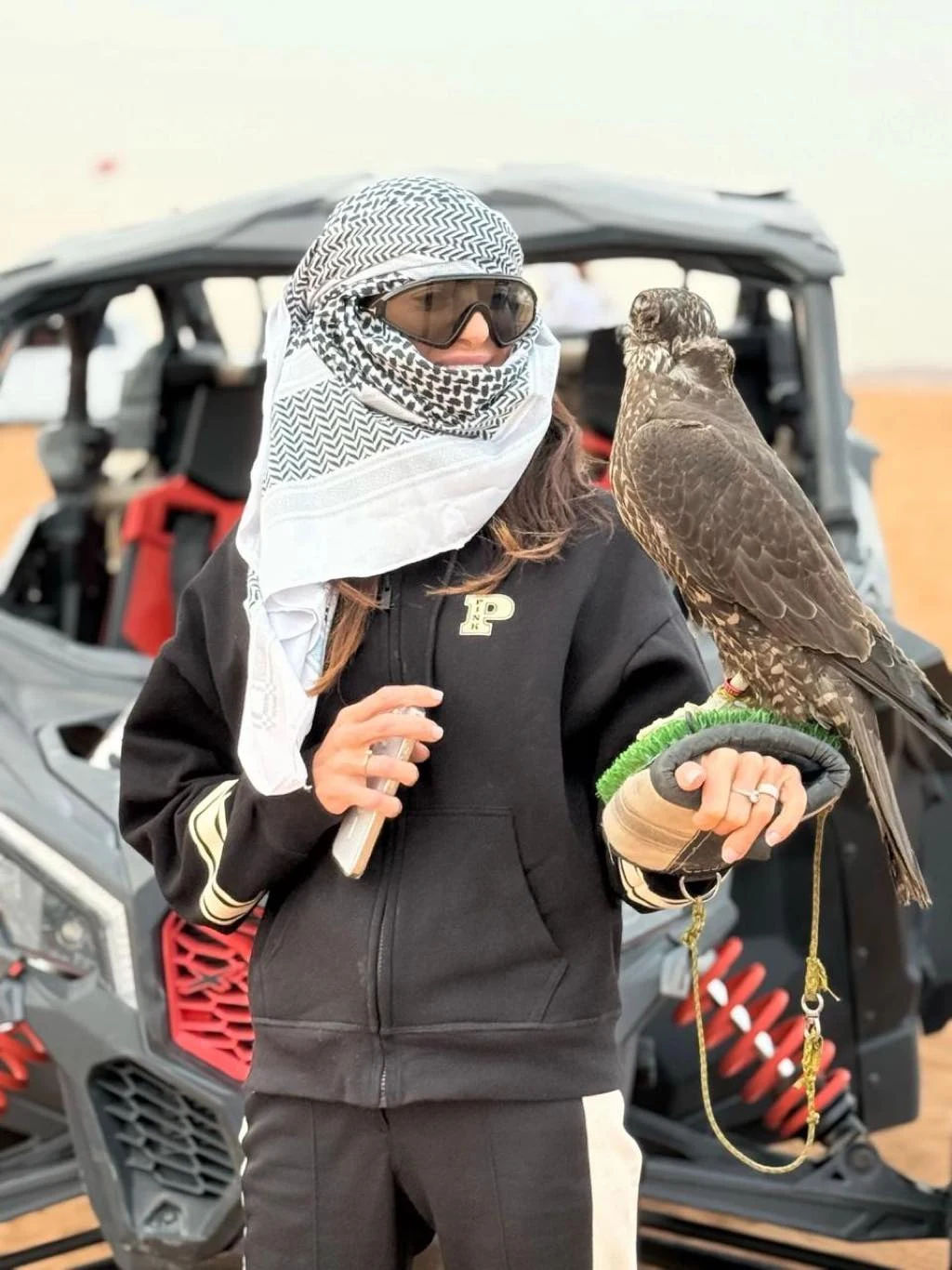 Guest enjoying a falcon experience in the desert